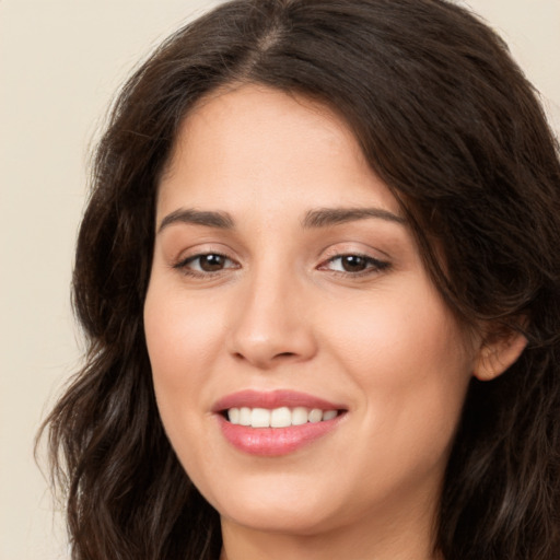 Joyful white young-adult female with long  brown hair and brown eyes