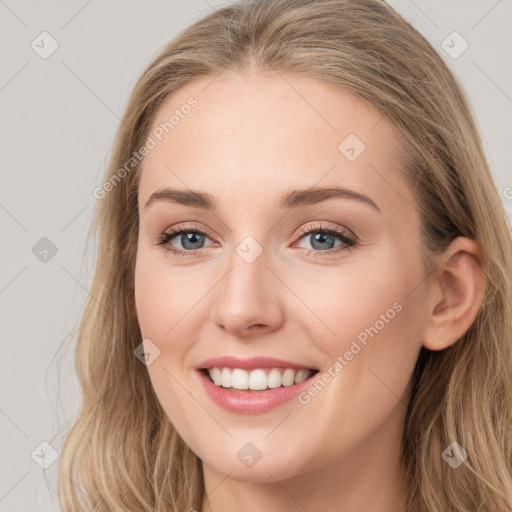 Joyful white young-adult female with long  brown hair and blue eyes