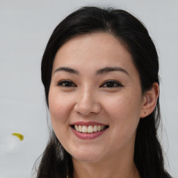 Joyful asian young-adult female with long  brown hair and brown eyes