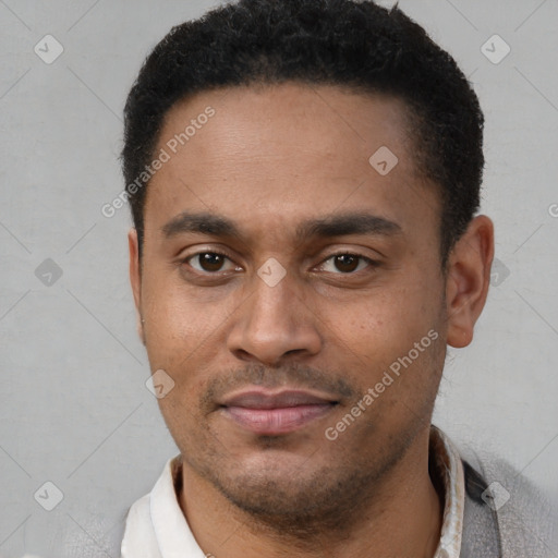 Joyful latino young-adult male with short  brown hair and brown eyes