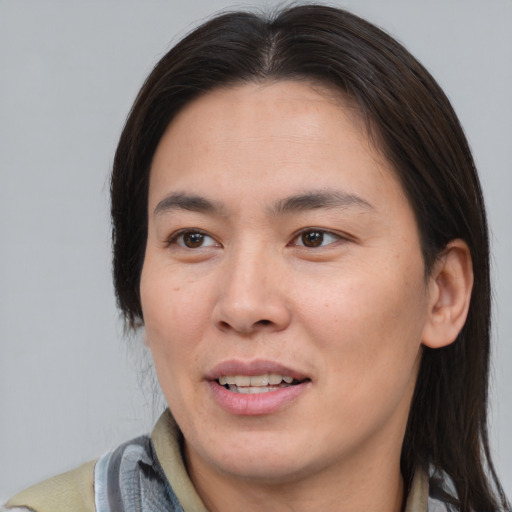 Joyful asian young-adult female with medium  brown hair and brown eyes