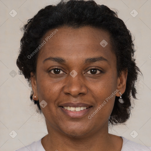 Joyful black adult female with short  brown hair and brown eyes