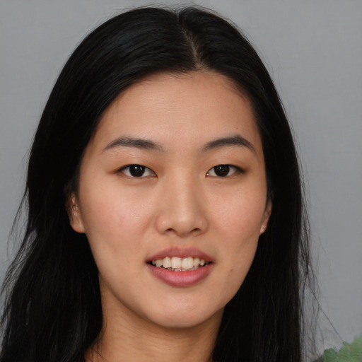 Joyful asian young-adult female with long  black hair and brown eyes