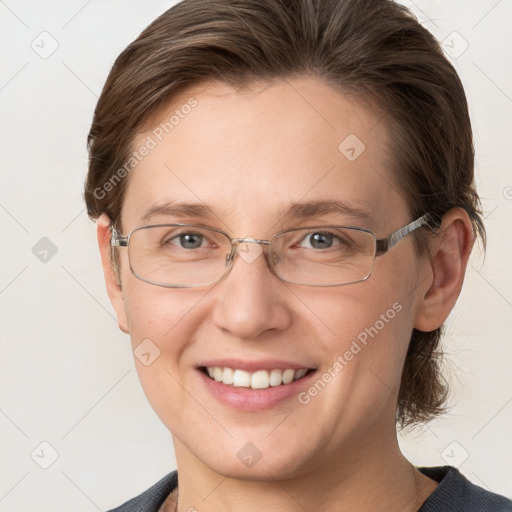 Joyful white adult female with medium  brown hair and grey eyes