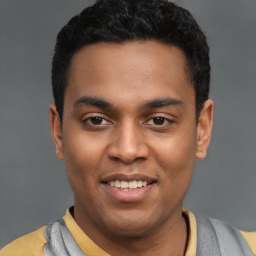 Joyful latino young-adult male with short  black hair and brown eyes