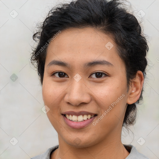 Joyful latino young-adult female with short  brown hair and brown eyes