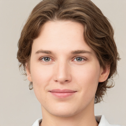 Joyful white young-adult female with medium  brown hair and green eyes