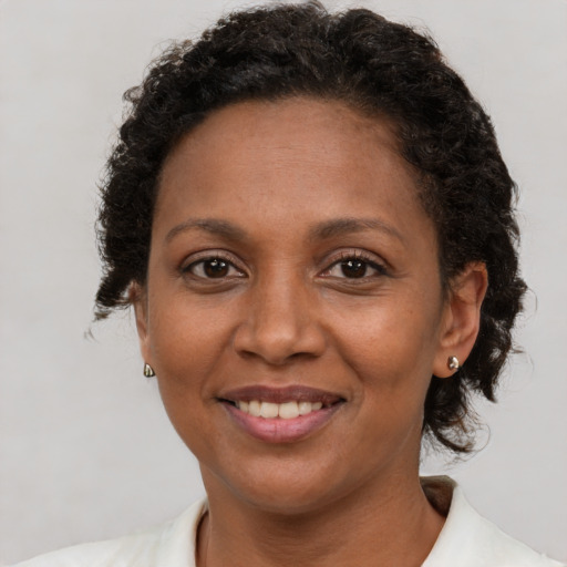 Joyful latino adult female with short  brown hair and brown eyes
