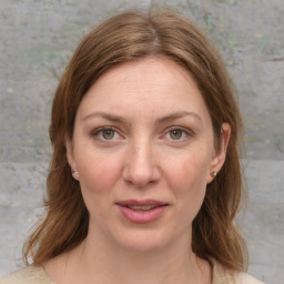 Joyful white young-adult female with medium  brown hair and blue eyes