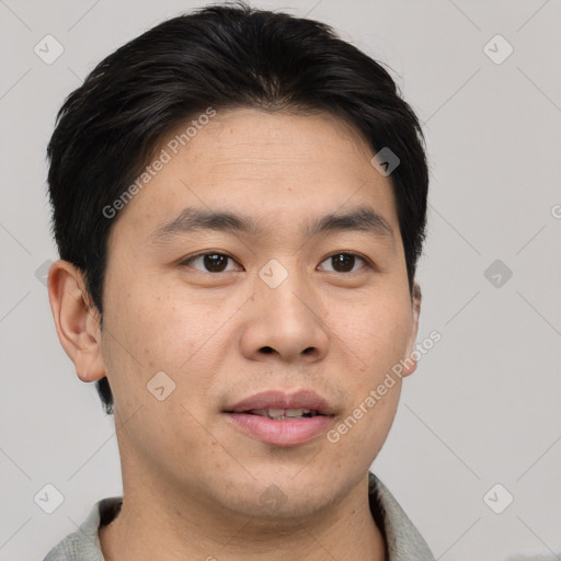 Joyful asian young-adult male with short  brown hair and brown eyes