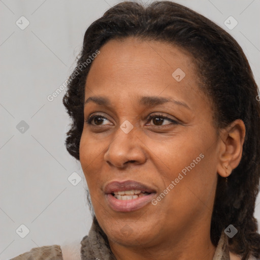 Joyful black adult female with medium  brown hair and brown eyes