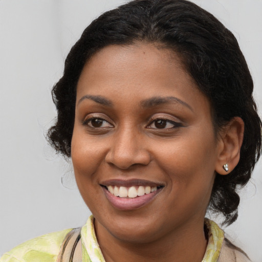 Joyful black young-adult female with medium  brown hair and brown eyes