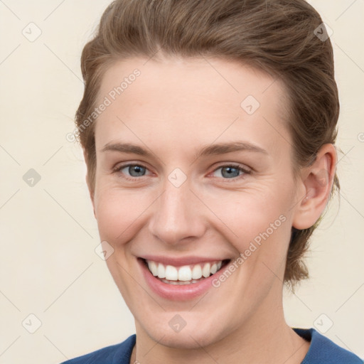 Joyful white young-adult female with short  brown hair and grey eyes