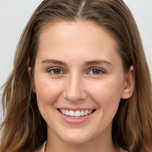 Joyful white young-adult female with long  brown hair and grey eyes