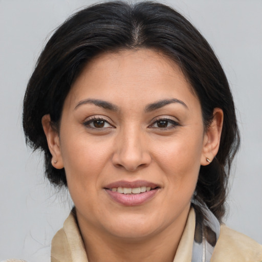 Joyful white adult female with medium  brown hair and brown eyes