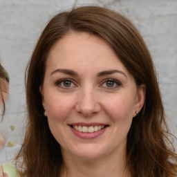 Joyful white young-adult female with long  brown hair and green eyes