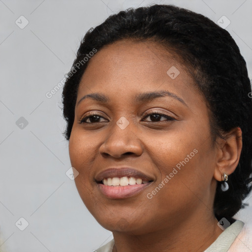 Joyful black young-adult female with short  black hair and brown eyes