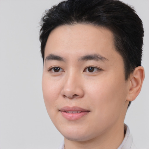 Joyful asian young-adult male with short  brown hair and brown eyes