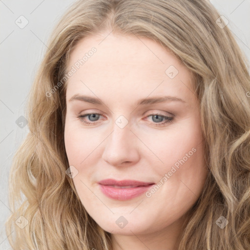 Joyful white young-adult female with long  brown hair and blue eyes