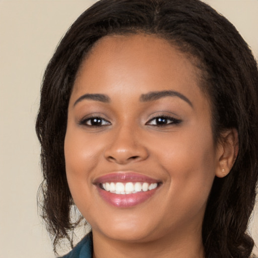 Joyful latino young-adult female with long  brown hair and brown eyes