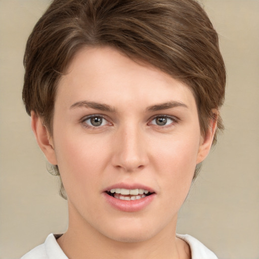 Joyful white young-adult female with short  brown hair and grey eyes