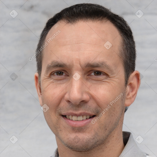 Joyful white adult male with short  brown hair and brown eyes