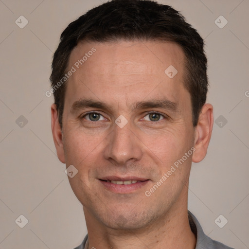 Joyful white adult male with short  brown hair and grey eyes