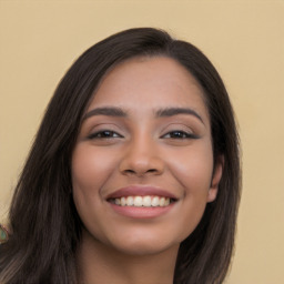 Joyful latino young-adult female with long  black hair and brown eyes