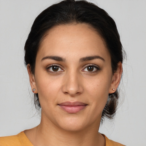 Joyful latino young-adult female with medium  brown hair and brown eyes