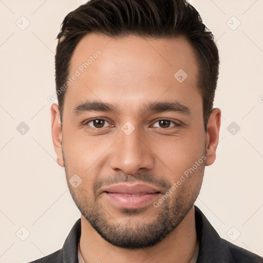 Joyful white young-adult male with short  brown hair and brown eyes