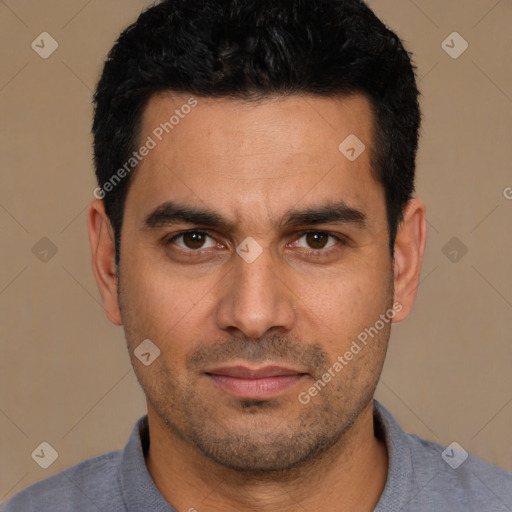 Joyful white young-adult male with short  black hair and brown eyes