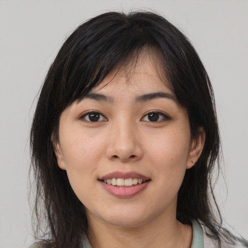 Joyful asian young-adult female with medium  brown hair and brown eyes