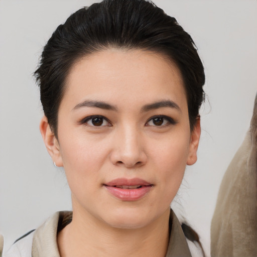 Joyful asian young-adult female with medium  brown hair and brown eyes
