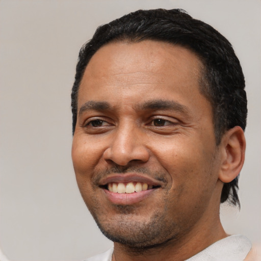 Joyful white adult male with short  black hair and brown eyes