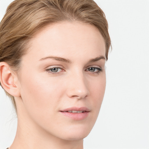 Joyful white young-adult female with long  brown hair and blue eyes