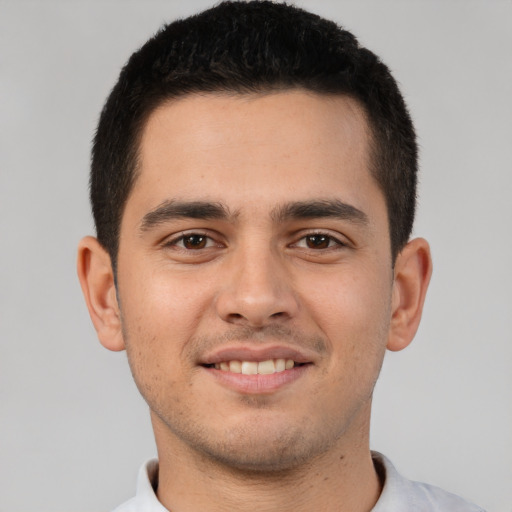 Joyful white young-adult male with short  brown hair and brown eyes