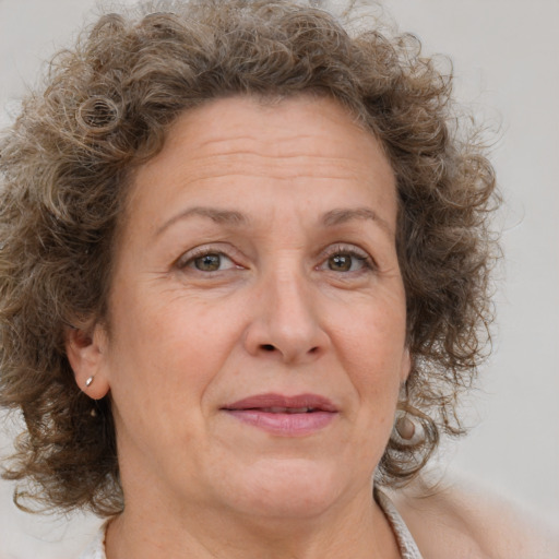 Joyful white middle-aged female with medium  brown hair and brown eyes