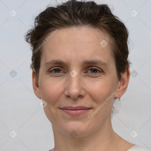 Joyful white adult female with short  brown hair and grey eyes