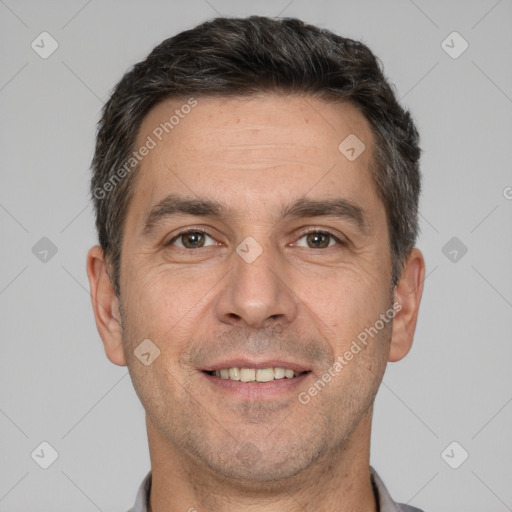 Joyful white adult male with short  brown hair and brown eyes