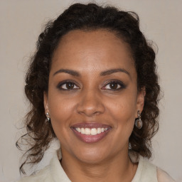 Joyful black young-adult female with medium  brown hair and brown eyes