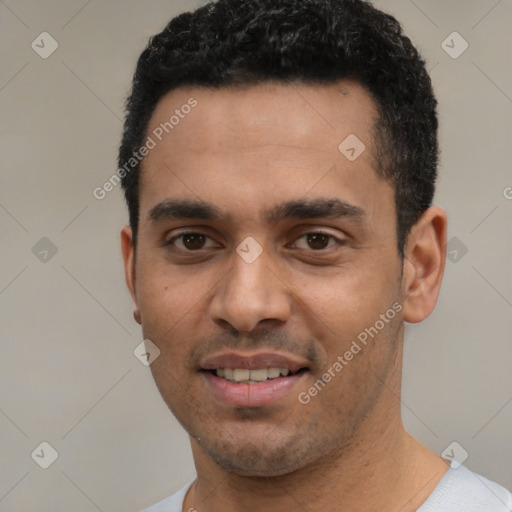 Joyful latino young-adult male with short  black hair and brown eyes