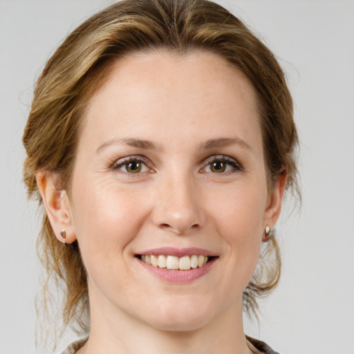 Joyful white young-adult female with medium  brown hair and green eyes