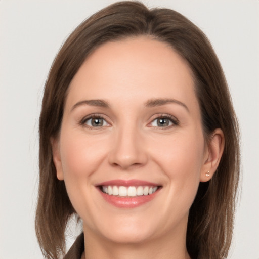 Joyful white young-adult female with long  brown hair and grey eyes