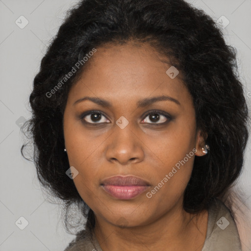 Joyful black young-adult female with long  brown hair and brown eyes