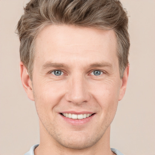 Joyful white adult male with short  brown hair and grey eyes