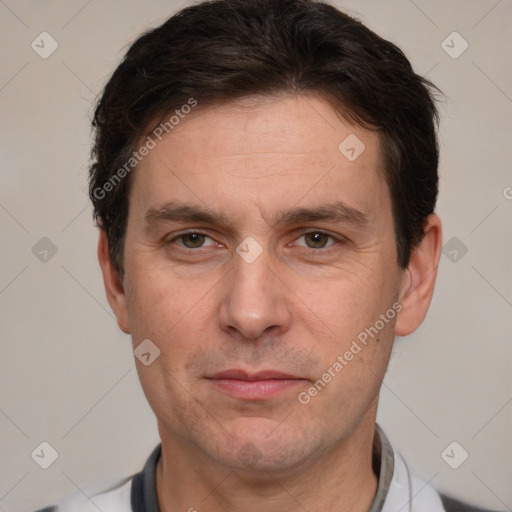 Joyful white adult male with short  brown hair and grey eyes