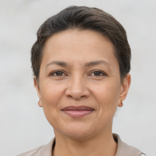 Joyful white adult female with short  brown hair and brown eyes