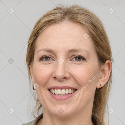 Joyful white adult female with medium  brown hair and grey eyes