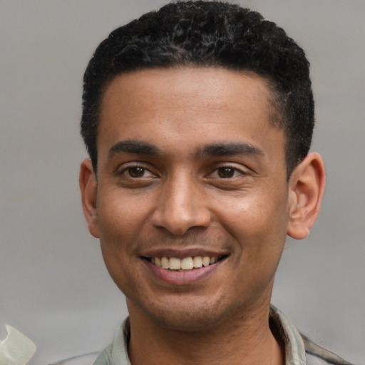 Joyful latino young-adult male with short  black hair and brown eyes