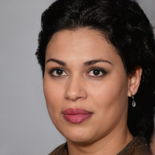 Joyful latino young-adult female with medium  black hair and brown eyes